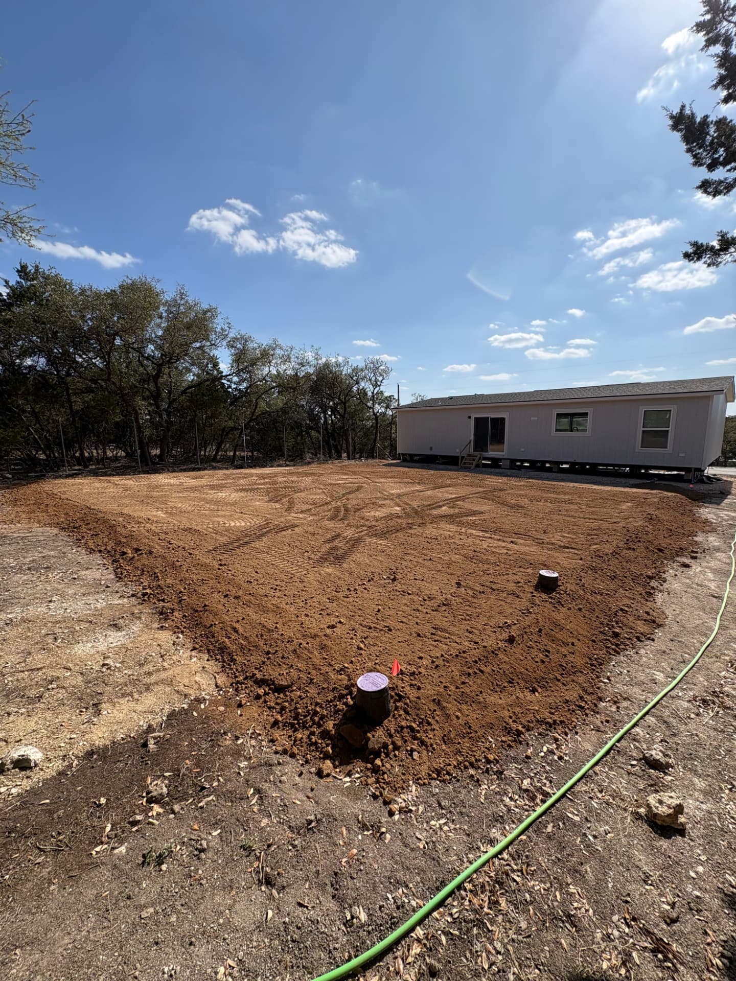 Completed septic installation with clean-outs set and yard restored to grade