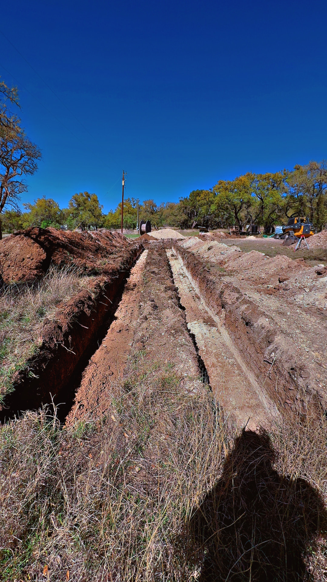 Long straight septic trenches cut through Hill Country soil
